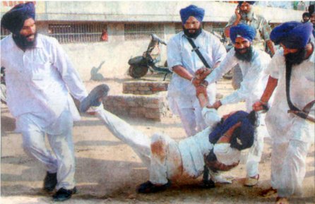 SGPC Task Force members dragging Bhai Mukhtiar Singh of Patiala by his sacred hair.  Bhai Mukhtiar Singh came to talk to  Avtar Makkar regarding the disrespect of Guru Ganth Sahib Ji attacked by  SGPC 'task force'. <br />