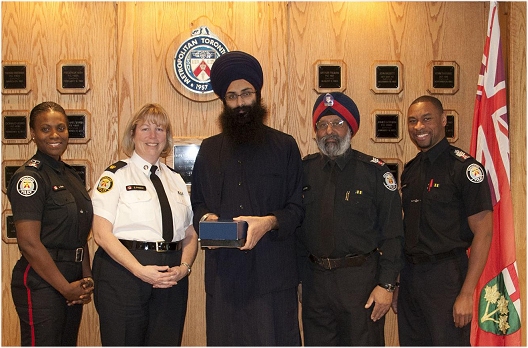 Balpreet Singh, WSO Legal Counsel, with Toronto Police Officials